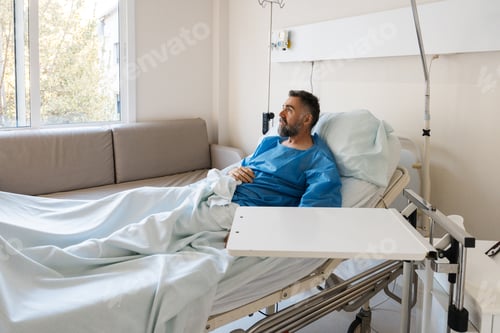 Preview: Recovering patient relaxing in hospital bed looking out window