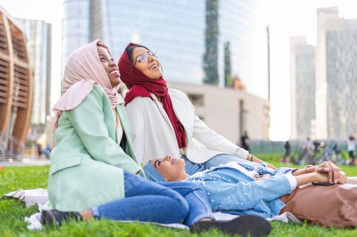 Preview: Beautiful muslim girl wearing hijab bonding outdoors