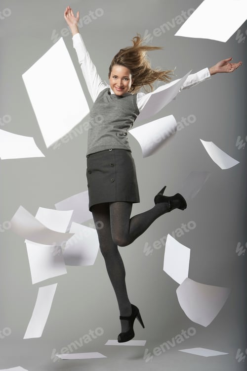Preview: Woman jumping with flying papers