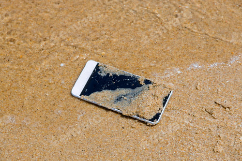 Preview: The Cell phone fall to the sea water near the on the sandy beach