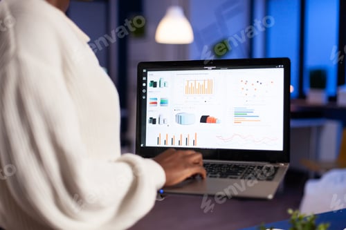 Preview: Close up of african woman working overtime late at night