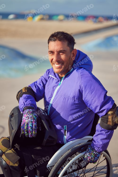 Preview: smiling athlete man with disability in wheelchair at skatepark