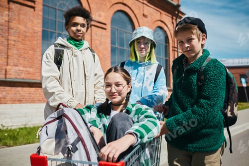 Preview: Teens playing with cart outdoors