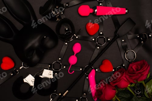 Preview: Set of adult toys on a dark background with red roses