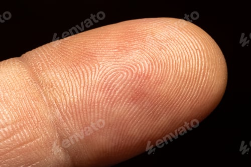 Preview: Closeup shot of a human finger skin on a black background