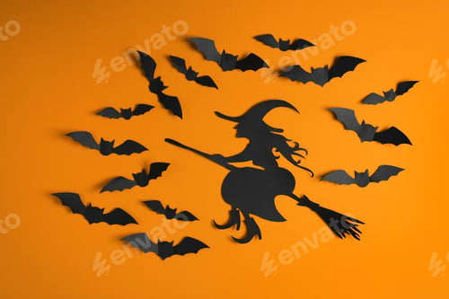 Preview: Paper bats and witch cutout on color background. Halloween decor
