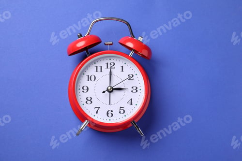 Preview: One red alarm clock on blue background, top view