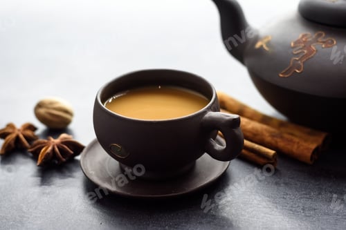 Preview: Masala tea in a clay mug and teapot. Traditional Indian hot drink