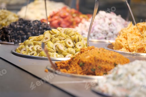 Preview: A colorful assortment of olives, fresh salads, and aromatic spices on display for all.