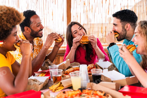 Preview: Multiethnic group of friends having dinner barbecue party on rooftop at home