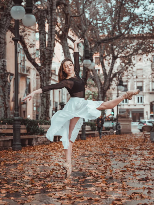 Preview: Young woman with leg stretched above head on street