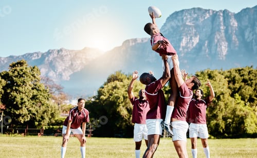 Preview: Team, ball or rugby men lifting a man together in training, exercise or workout match on sports fie
