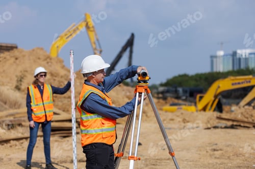 Preview: Two construction surveyors at a worksite