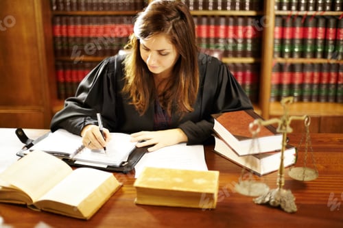 Preview: Shot of a young legal professional sitting at her desk in a study