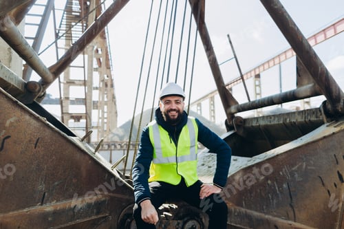 Preview: Construction worker sitting on heavy machinery at concrete production plant