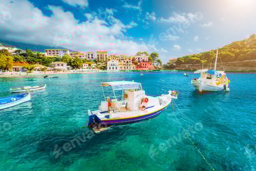 Preview: Assos village on Kefalonia island, Greece. White boats in the emerald rippled sea water bay
