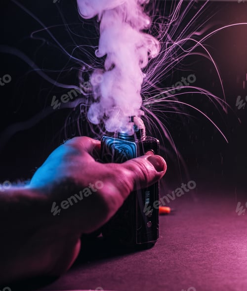 Preview: Vertical shot of a male hand holding a vape