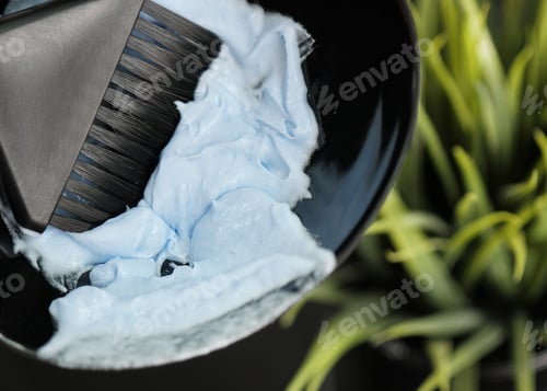Preview: The hairdresser kneads the hair dye in the salon. Hair coloring process