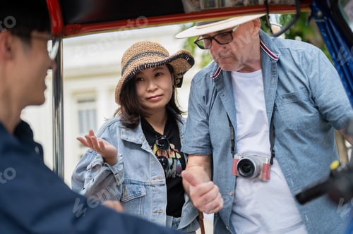 Preview: Old white man thump up to driver aside wife after riding in tuk tuk three wheel taxi touring a city.