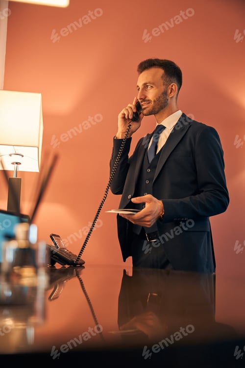Preview: Confident man smiling during the conversation on the phone