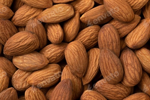 Preview: Peeled brown almonds close up full frame