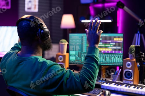 Preview: Man Producing Music in Home Recording Studio