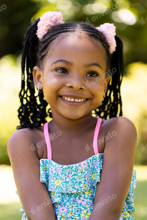 Preview: Closeup portrait of smiling african american cute girl with dreadlocks looking away
