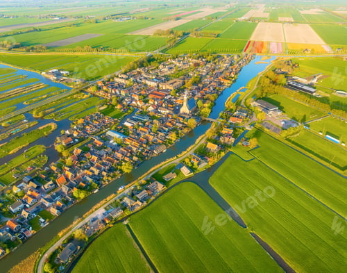 Preview: Aerial panoramic view of a traditional Dutch village with canals, houses and green farmland fields