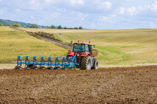 Preview: Plowing the field. Large plow on a tractor. Tractor with agricultural attachment.