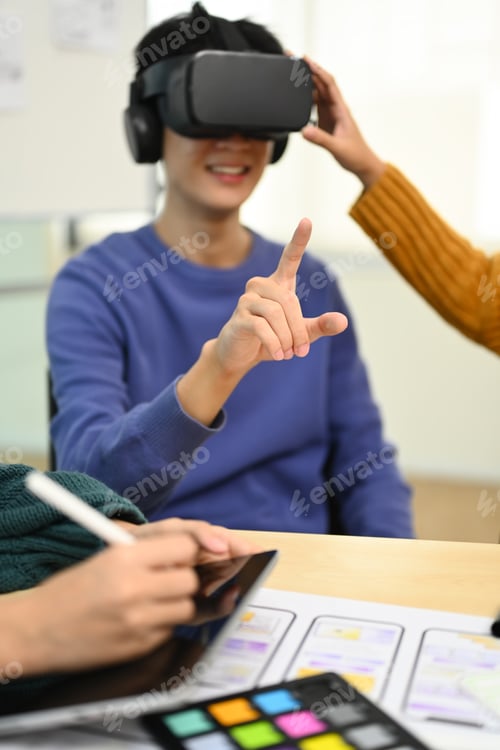 Preview: Young Creative man wearing VR headset start up team discussing about new digital projects.