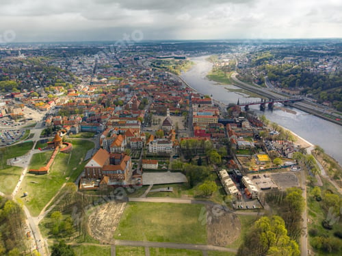 Preview: Aerial view shot of beautiful green fields and houses of the countryside on a sunny day