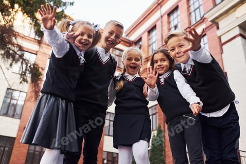 Preview: Group of kids in school uniform that is outdoors together near education building