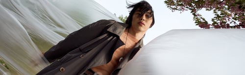 Preview: Stylish young man embraces fashion in a serene park setting during spring days