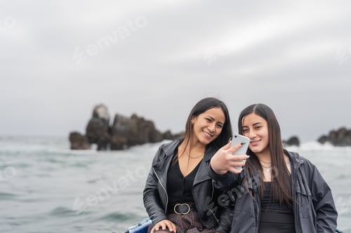 Preview: Two friends taking selfie from a boat