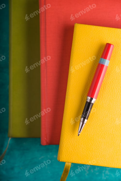 Preview: Color pads and a pen on a turquoise table