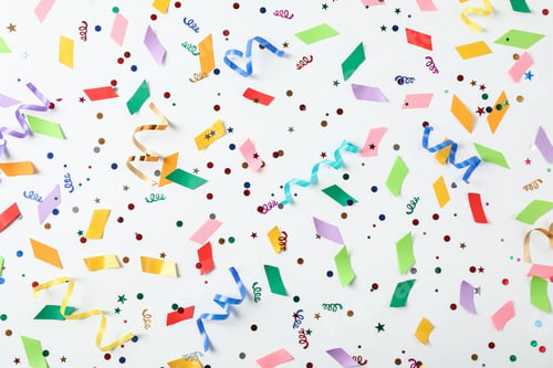 Preview: Colorful confetti and streamers on white background, top view