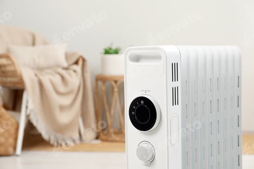 Preview: Modern portable electric heater indoors, closeup. Space for text
