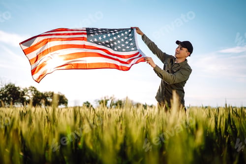 Preview: Man hold waving american USA flag. Patriot raise national american flag. Independence Day, 4th July.