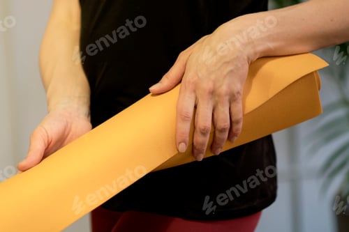 Preview: Young woman holding a yoga mat. woman practicing yoga concept