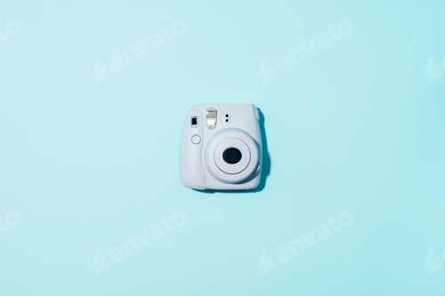 Preview: Vilnius, Lithuania - September 16, 2019: FUJIFILM INSTAX Mini Instant Film Camera on blue background