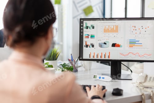 Preview: Businesswoman working at financial presentation analyzing company graphs