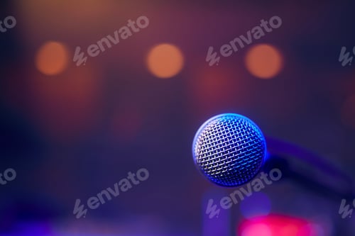 Preview: Microphone on stage against spotlights