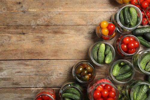 Preview: Pickling jars with fresh vegetables on wooden table, flat lay. Space for text