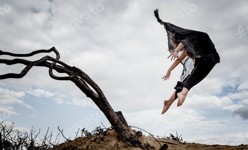 Preview: Woman posing in air near dry twigs and blue sky