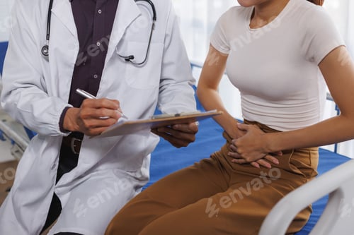 Preview: Doctor consulting woman experiencing abdominal stomach pain