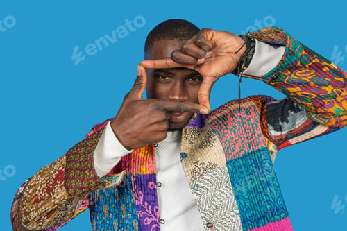 Preview: Stylish model framing face with hands, embracing creativity and fashion
