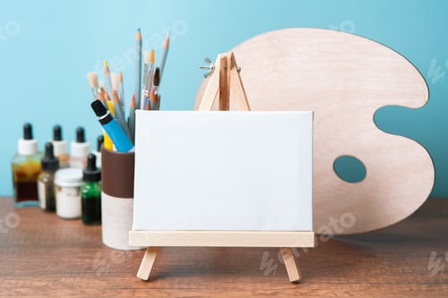Preview: Blank Canvas on Easel with Painting Supplies