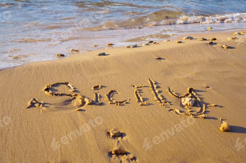 Preview: inscription word Sicily written on wet sand of beach seashore coastline after tide at sunset.
