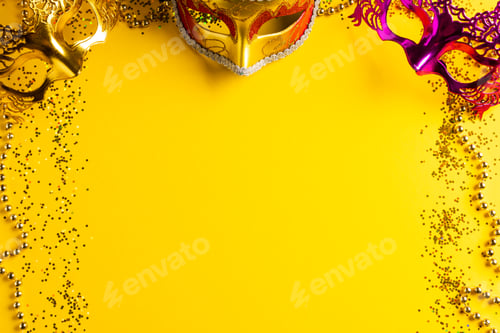 Preview: Composition of colourful mardi gras beads and carnival masks on yellow background with copy space