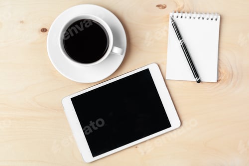 Preview: Digital tablet computer and cup of coffee on wooden desk
